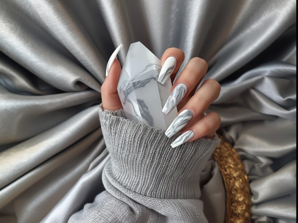  White and gray marble nail design with swirling patterns on a Pinterest board.