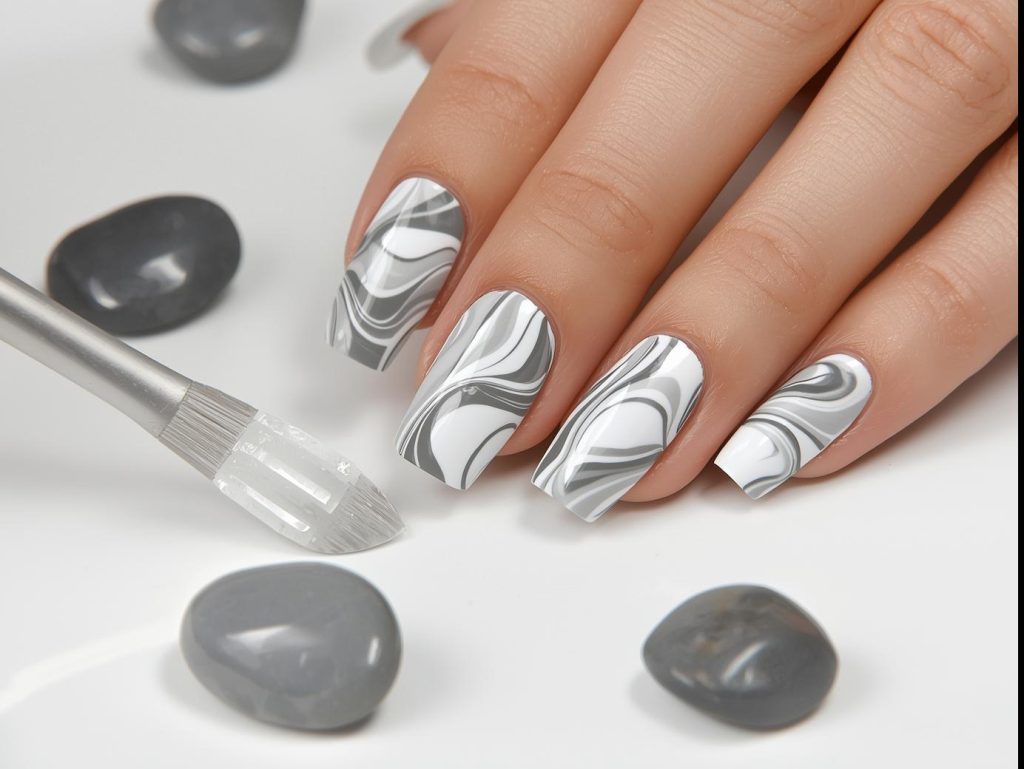 Creating swirling white and gray marble nails with swirled polish.