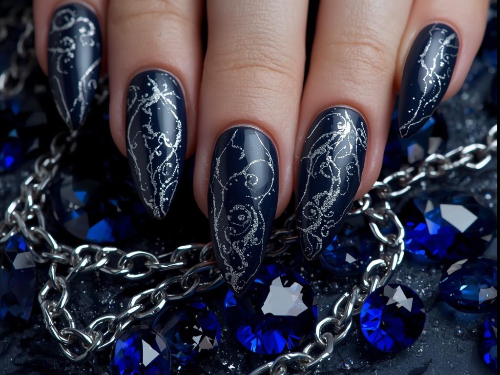  Deep navy and silver swirl marble nails with shimmering veining.