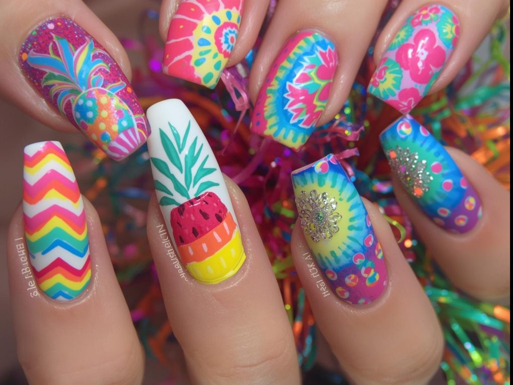 Colorful Nail Designs: Vibrant and Pinterest-Worthy Manicures to Obsess Over 2 Colorful nail designs with neon rainbow chevrons, tropical fruit patterns, tie-dye swirls, and confetti polka dots for captivating Pinterest inspiration.