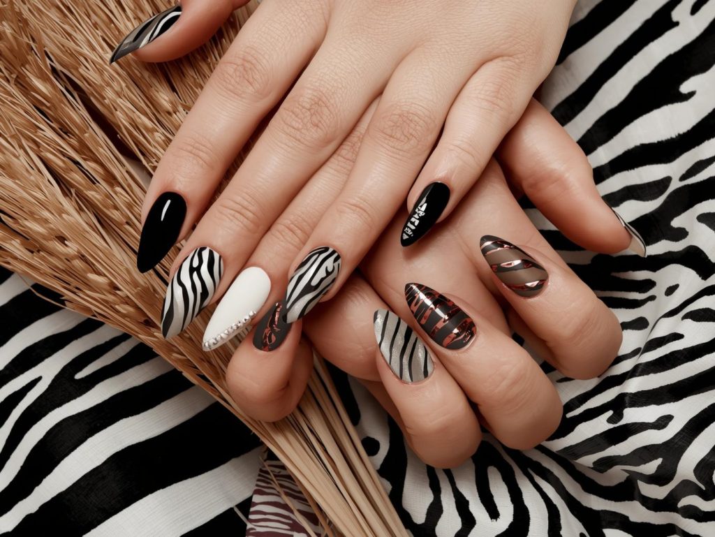 Zebra Print Nail Designs: Bold and Pinterest-Worthy Manicures to Adore 2 Zebra print nail designs with white zebra stripes, gold zebra accents, silver zebra patterns, and bronze zebra stripe details for captivating Pinterest inspiration.