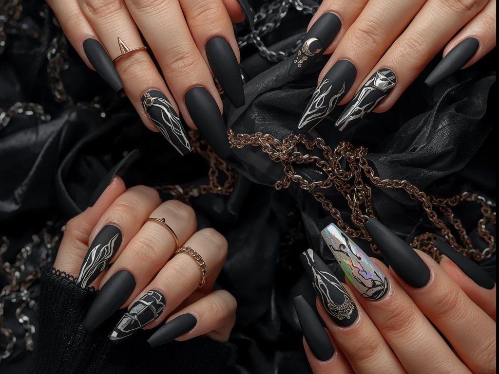  Matte black nail designs with silver foil geometrics, glossy black flames, gold stud embellishments, and holographic crescent moons for captivating Pinterest inspiration.