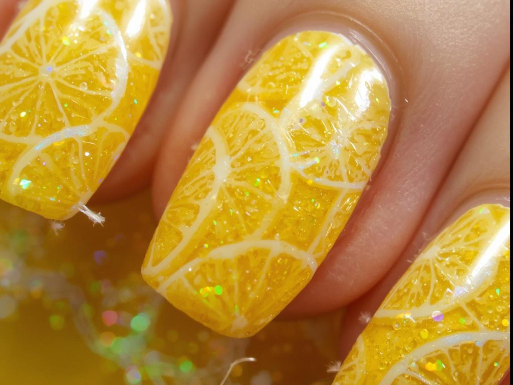 Glossy lemon yellow holographic lemon peel nail art with glossy finish.