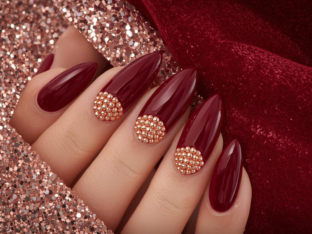 Glossy oxblood rose gold caviar bead nail art with glossy finish.