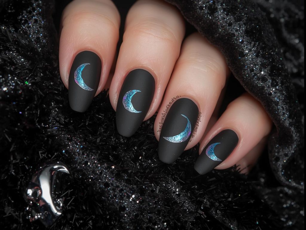 Matte black holographic crescent moon nail art with matte finish.