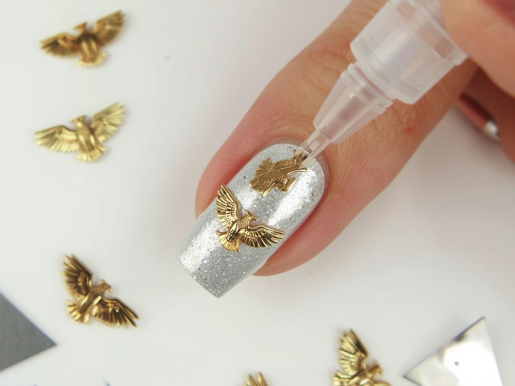 Creating shimmering silver gold eagle nail art with gold embellishment