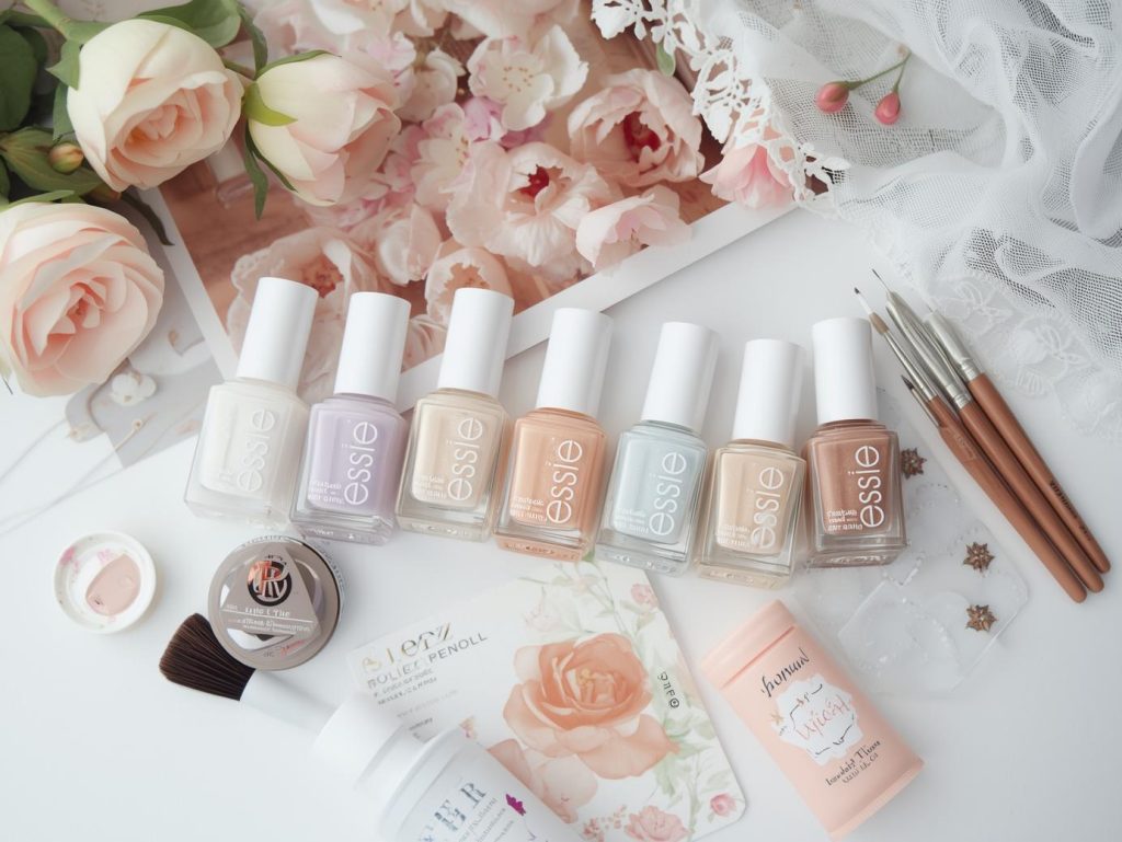 Nail art kit with polish and tools for floral French nail designs.