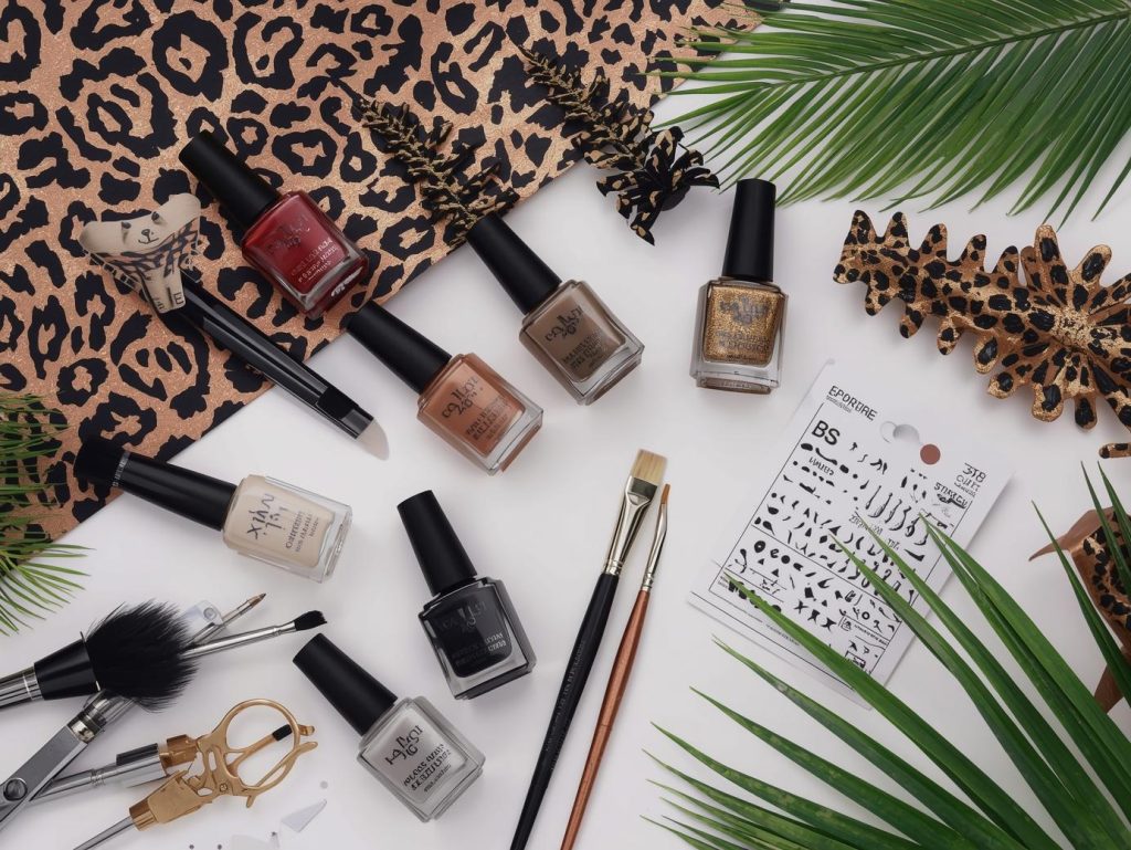 Nail art kit with polish and tools for leopard print nail designs.
