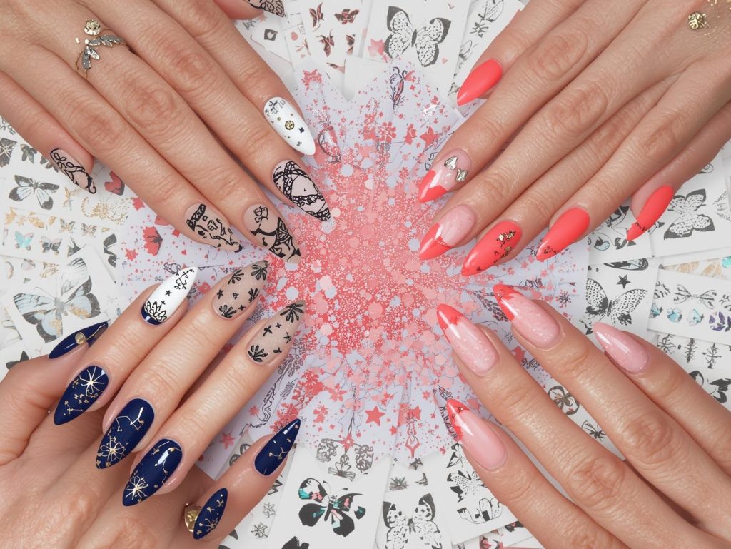 Top nail decal ideas featuring black lace decals, gold mandala decals, silver constellation decals, and holographic butterfly decals for Pinterest inspiration.