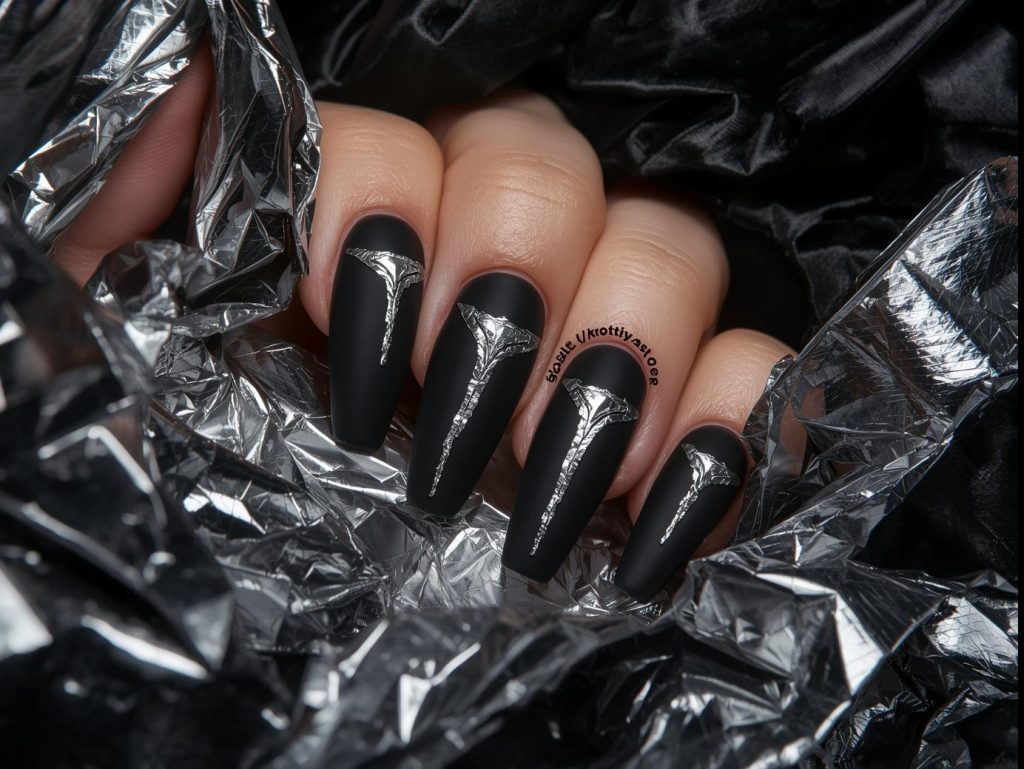  Sleek matte black silver foil geometric nail art with matte black base.