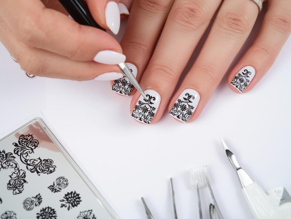 Creating glossy white black lace stamped nail art with black lace stamps.