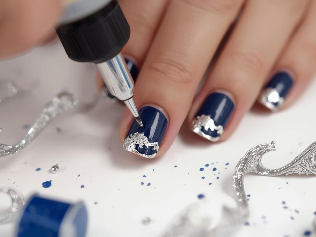 Creating rich navy blue silver foil wave nail art with silver foil.