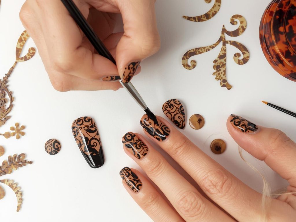 Creating rich amber black and caramel tortoise nail art with black and caramel swirl patterns.