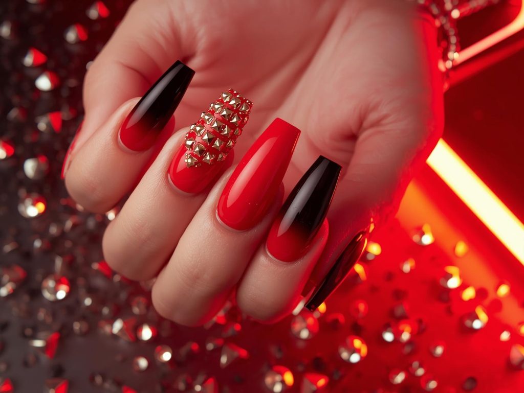  Vibrant red ombre nail art with gold stud embellishments.