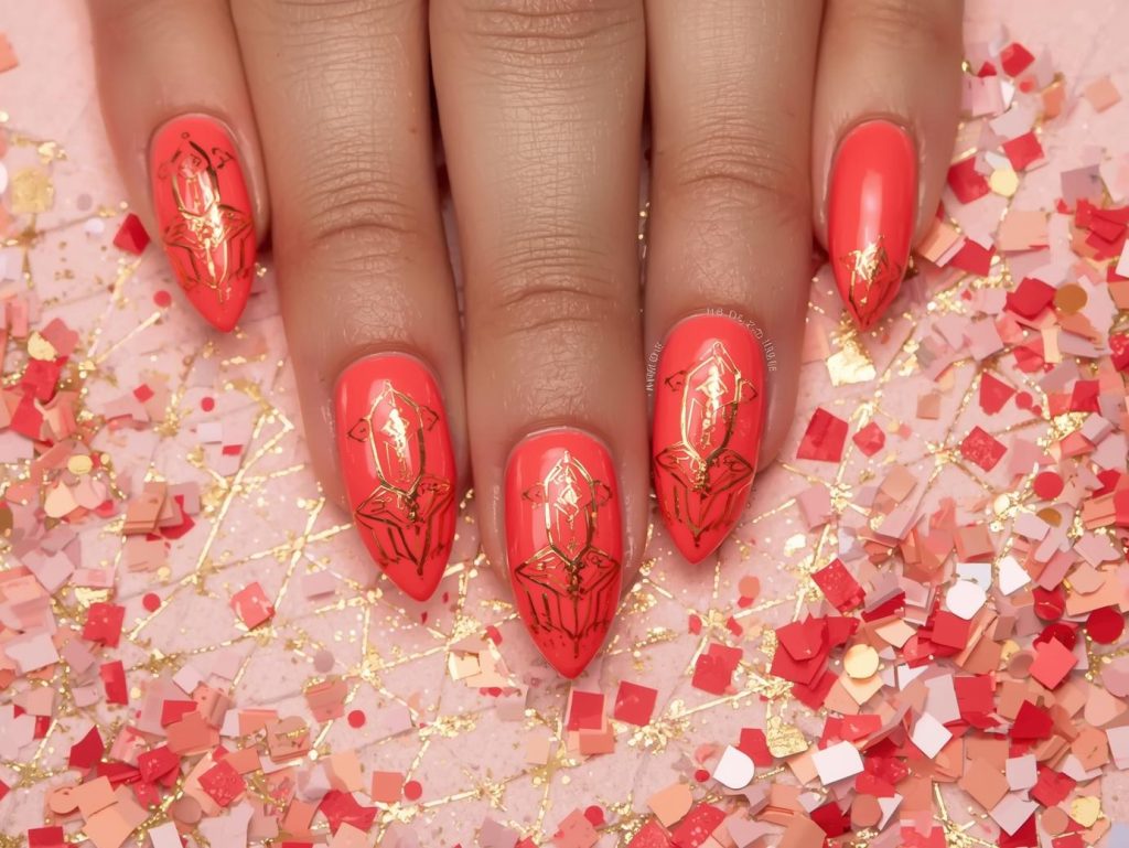 Vibrant coral gold geometric sticker nail art with gold stickers.