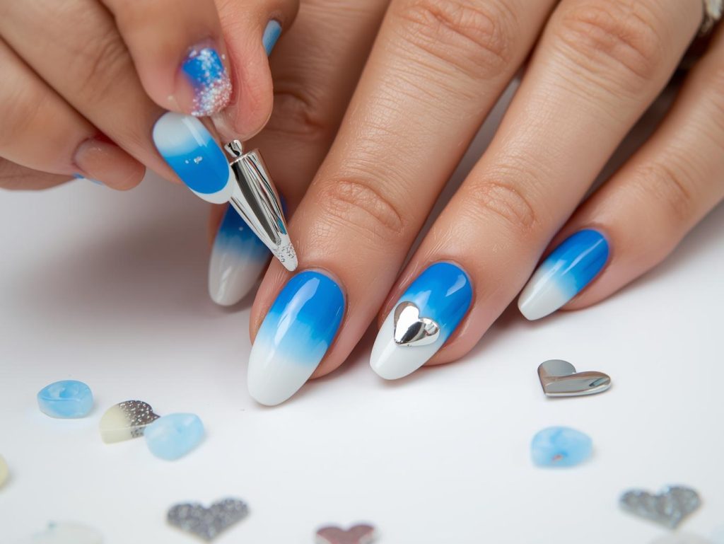 Creating electric blue ombre nail art with silver chrome heart accents.