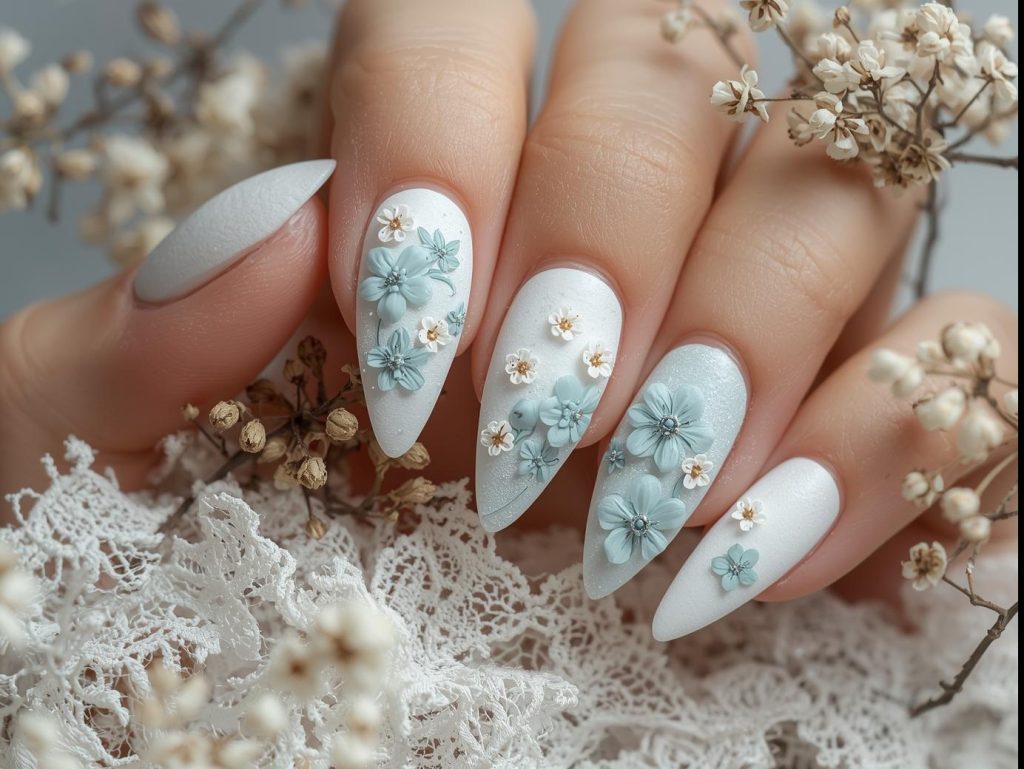 Textured floral pattern 3D nails with white and pastel blue designs.