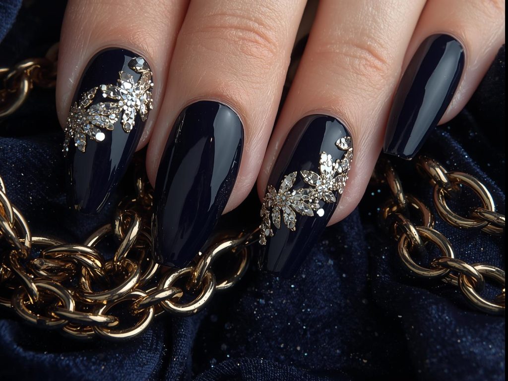 Shimmering gold mirror accent nail art with deep navy base.