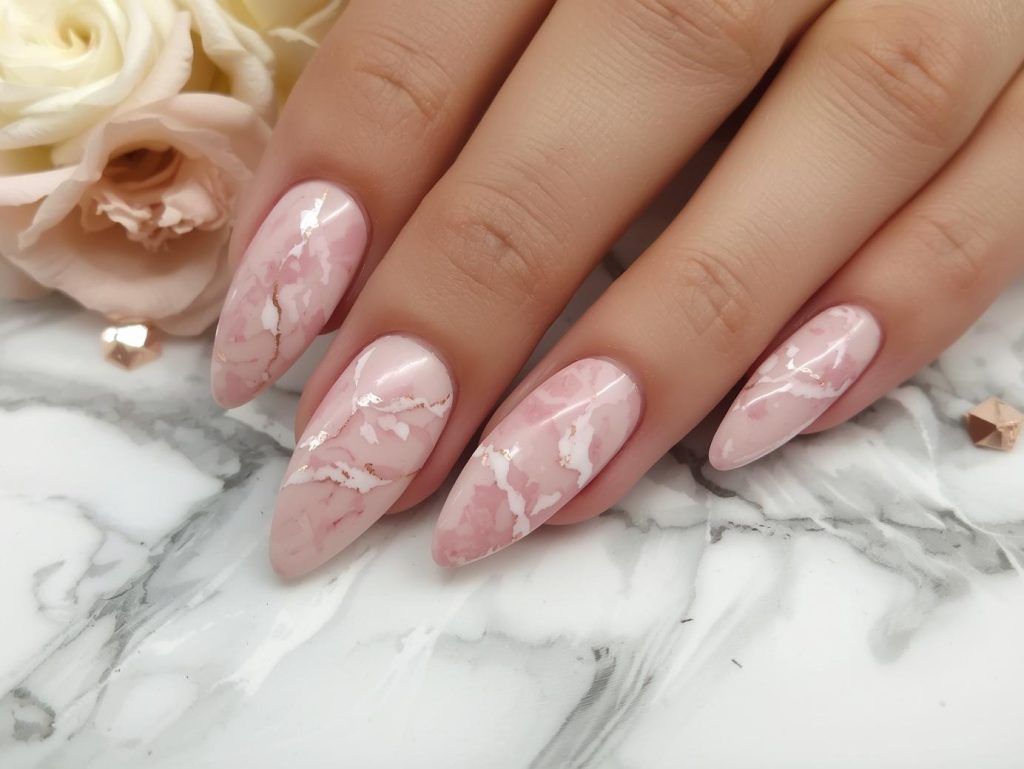Soft rose gold white marble nail art with white patterns.