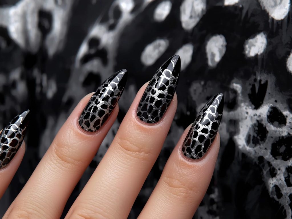 Glossy black silver cheetah nail art with silver patterns.