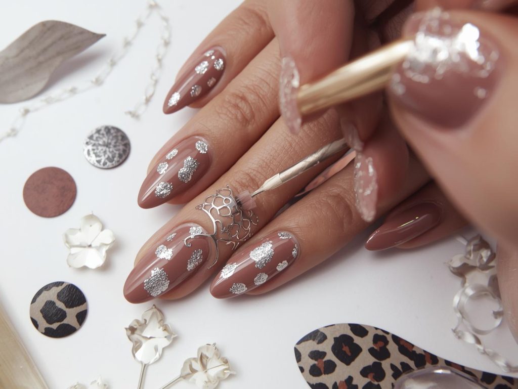 Creating glossy taupe silver leopard nail art with silver leopard patterns.