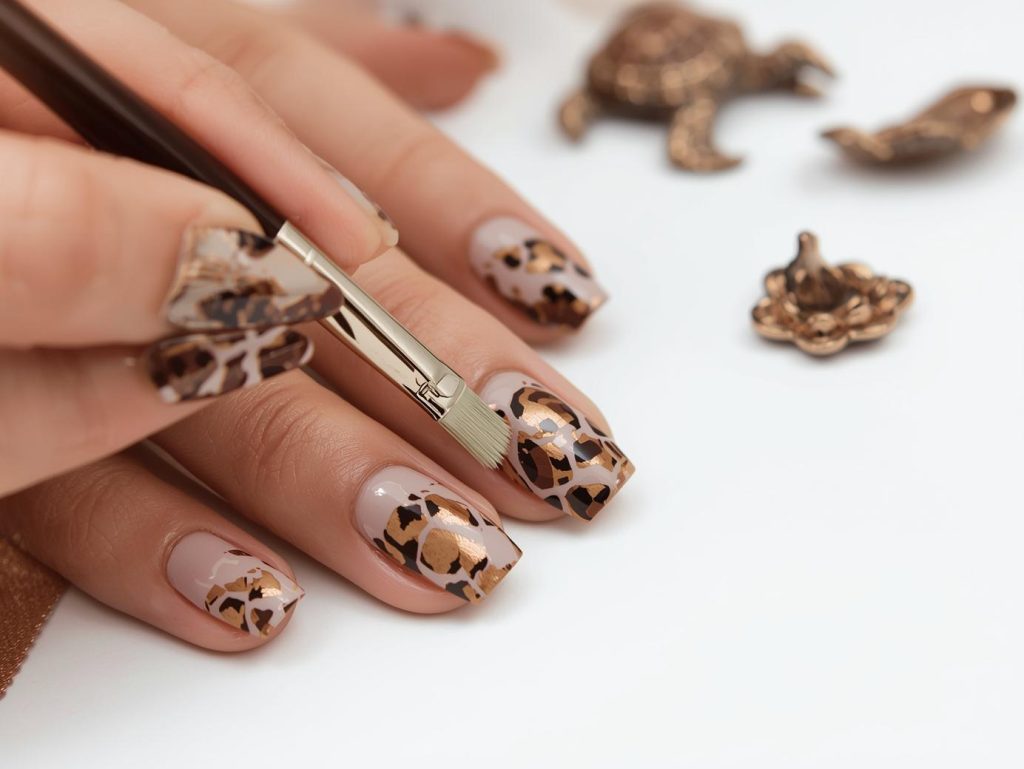  Creating glossy taupe bronze tortoise nail art with bronze tortoise patterns.