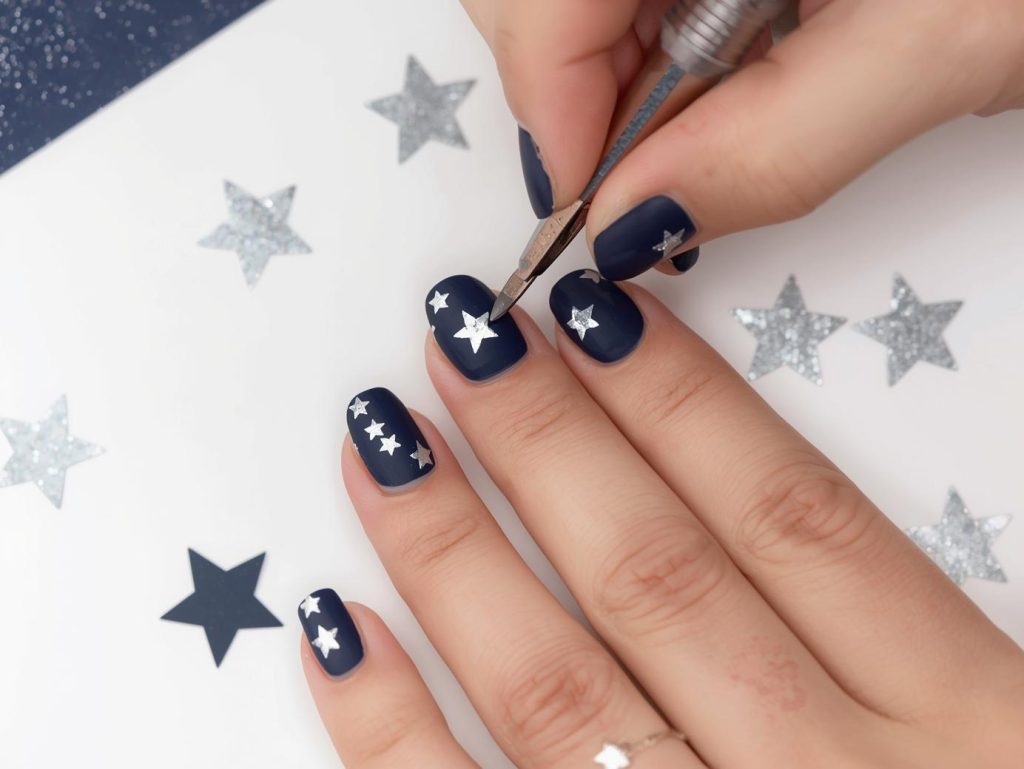  Creating matte navy silver star sticker nail art with silver star stickers.