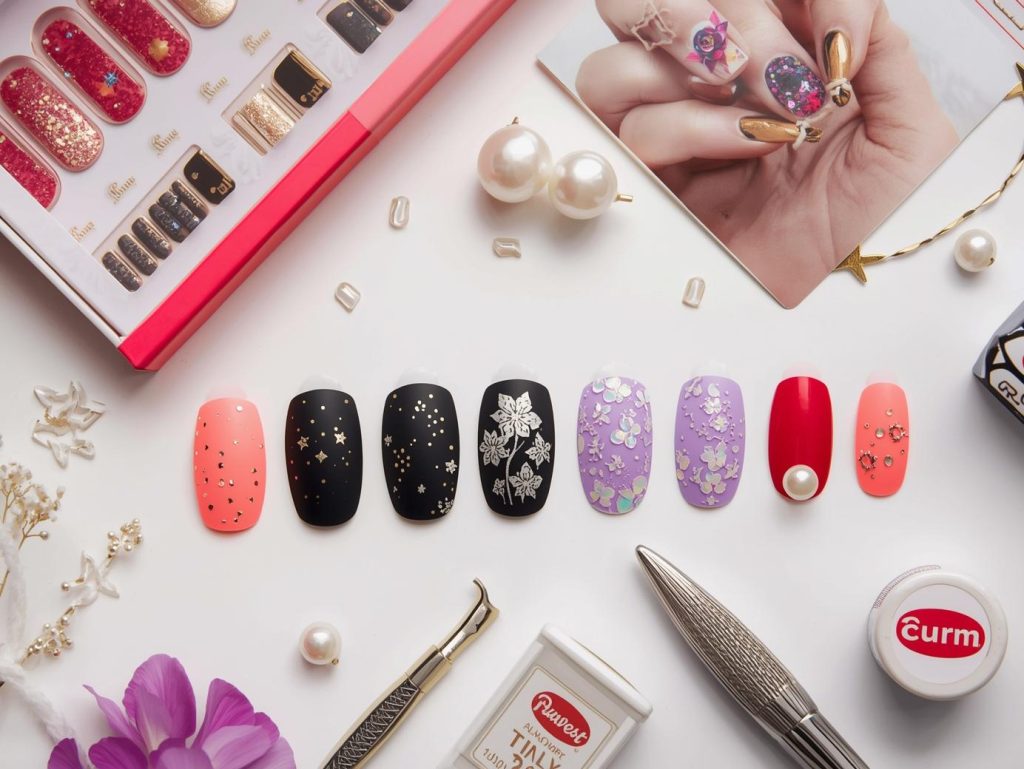 Press on nail kit with nail sets and tools for press on nail designs.
