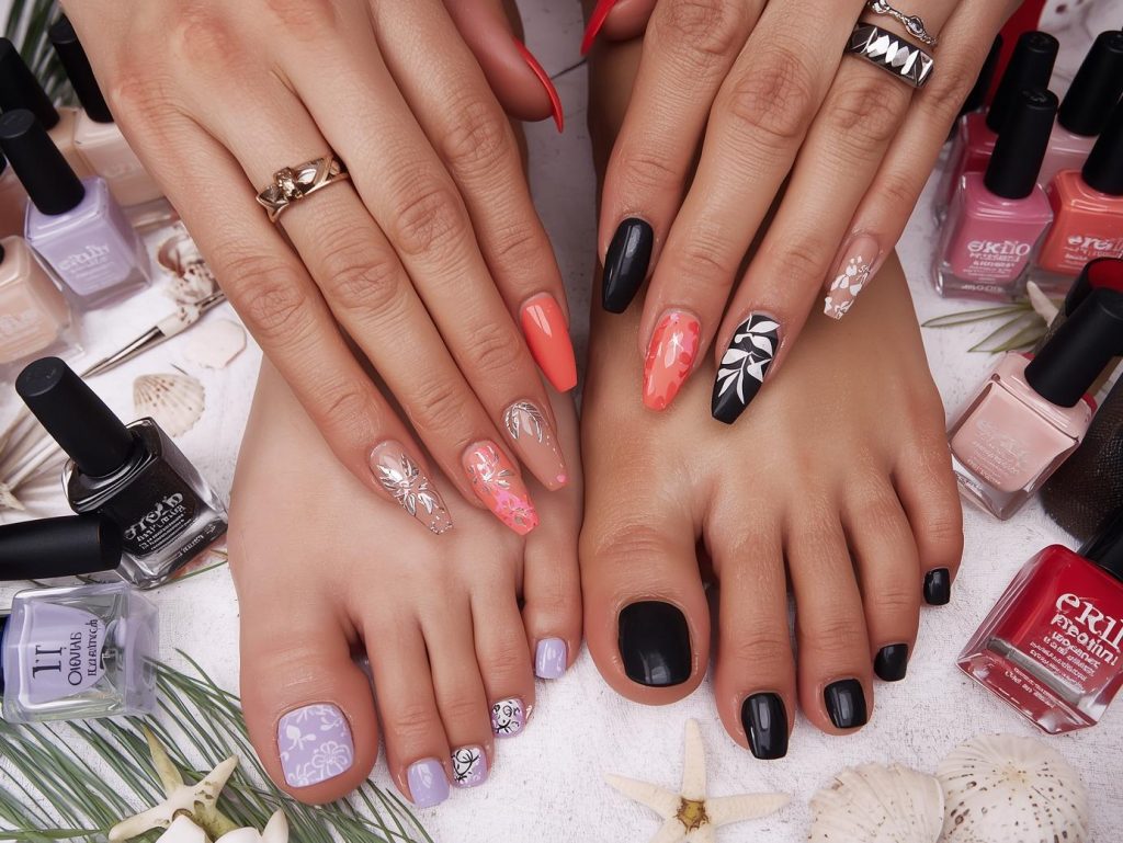 Matching Nails and Toes: Coordinated and Pinterest-Worthy Looks to Adore 2 Matching nails and toes with gold glitter accents, silver foil details, holographic leaf decals, and white floral stamping for captivating Pinterest inspiration.