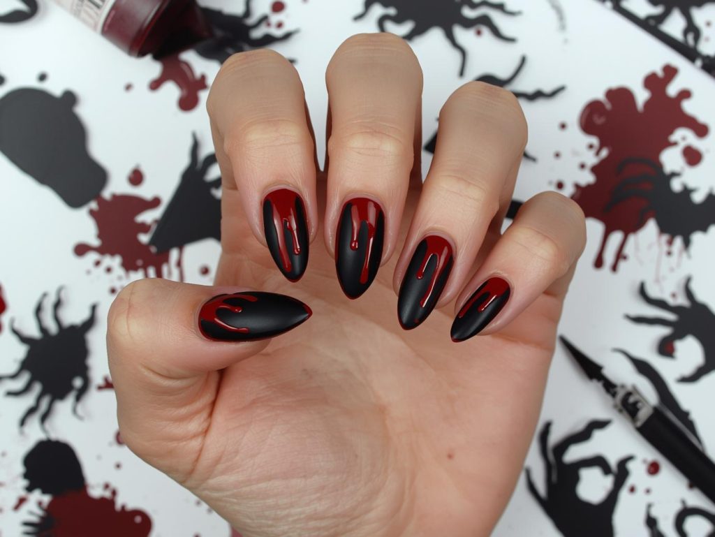 Deep black blood drip black Halloween nail design with red patterns.