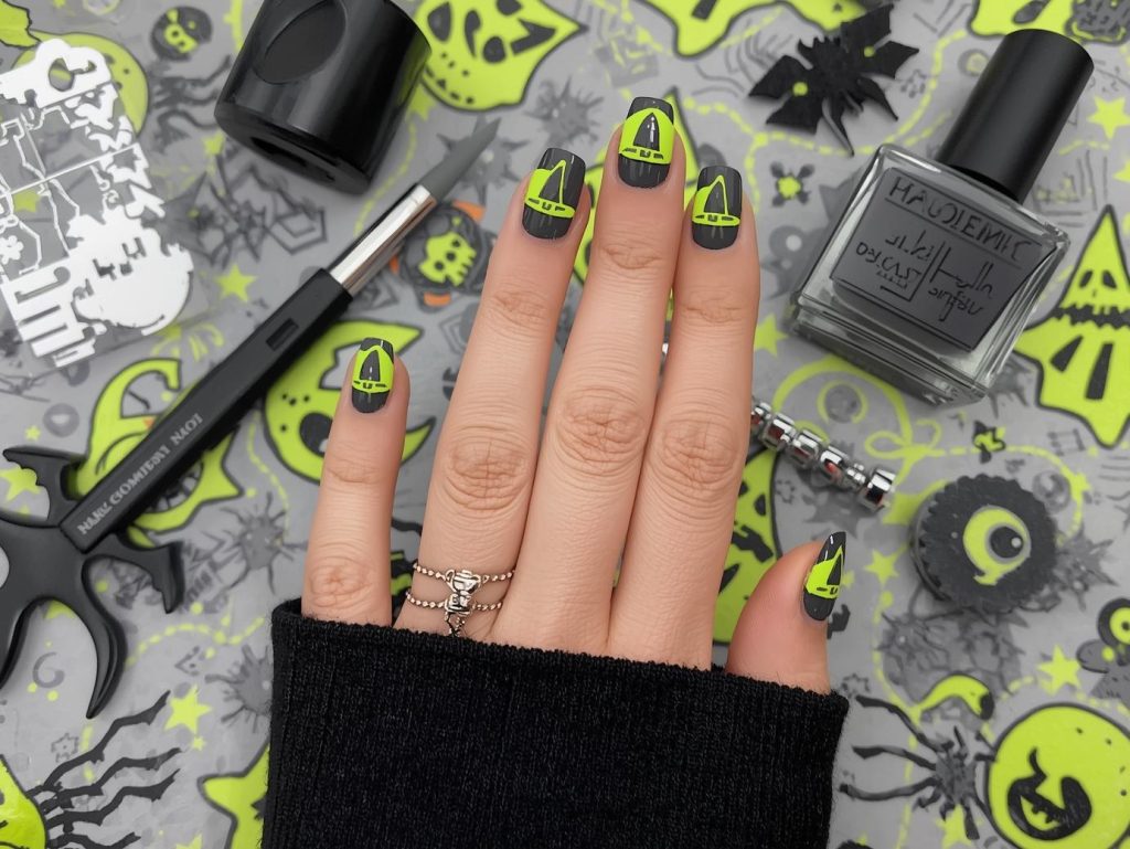 Charcoal gray witch hat short Halloween nail design with neon green accents.