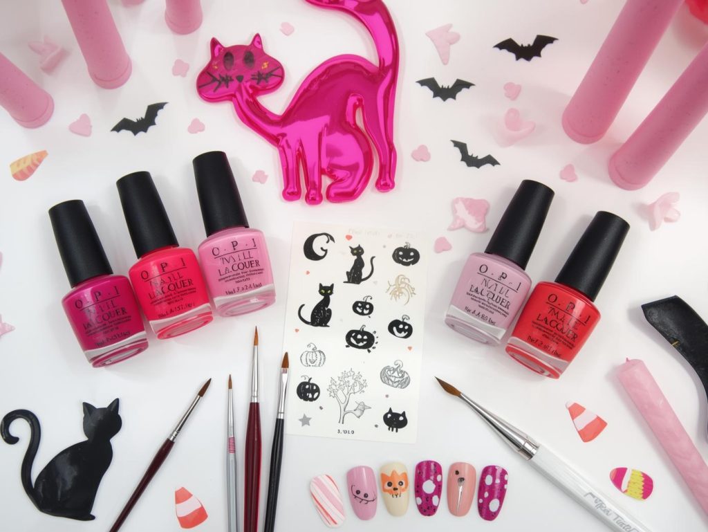 Pink Halloween nail kit with polish and tools for playful spooky designs.