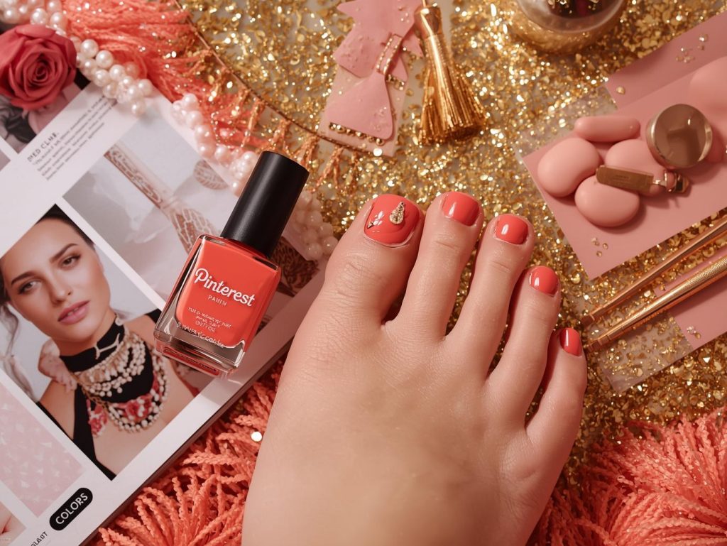 Glossy coral gold foil pedicure with coral base on a Pinterest board