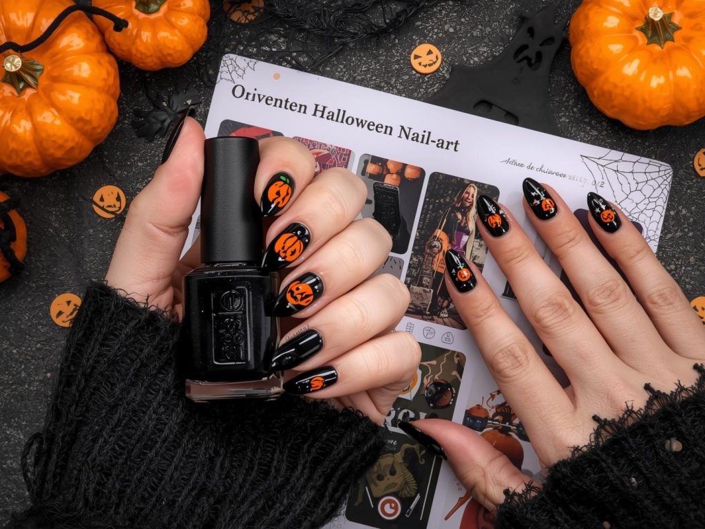  Glossy black pumpkin decal Halloween nail design with orange pumpkins on a Pinterest board.