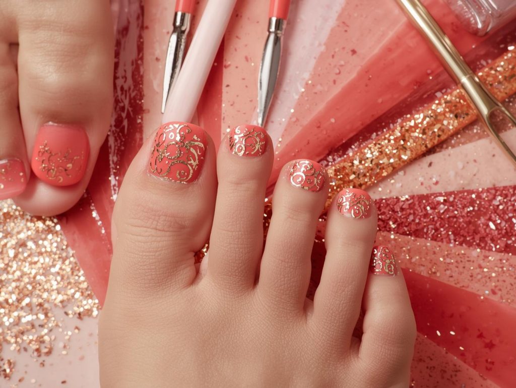  Glossy coral gold foil pedicure with coral base.